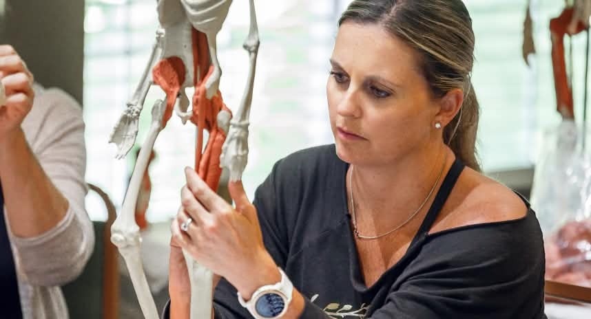 woman working with skeleton and clay model